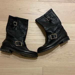 Jimmy Choo black leather ankle boot with gold buckle.